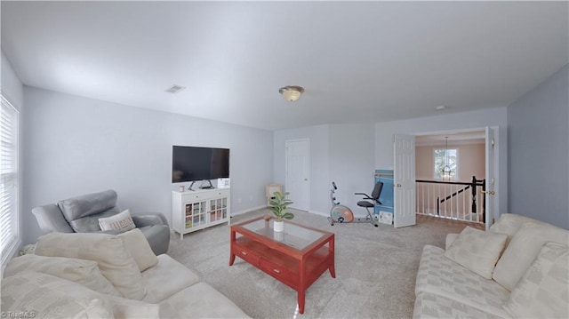 living room featuring carpet, visible vents, and baseboards