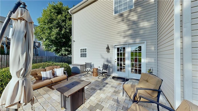 view of patio featuring french doors and fence