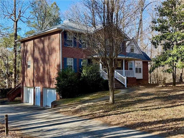 view of front of house featuring covered porch and a garage