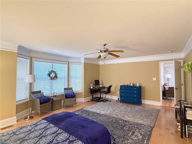 bedroom with ornamental molding, ceiling fan, and light hardwood / wood-style floors