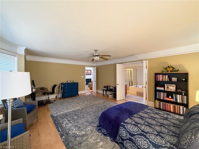 bedroom with ensuite bathroom, multiple windows, ceiling fan, and light hardwood / wood-style floors