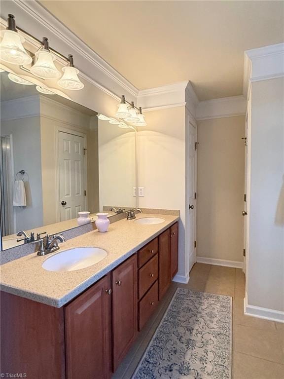 bathroom with crown molding, tile patterned floors, and vanity