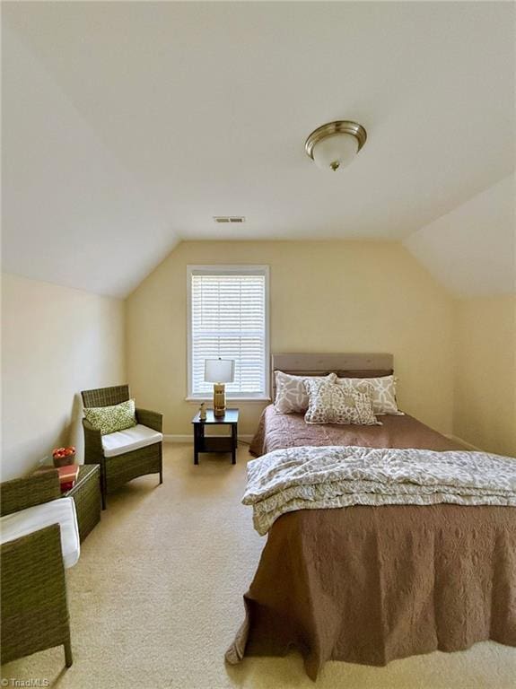 bedroom featuring lofted ceiling and carpet flooring