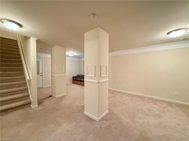 basement with ornamental molding and light colored carpet