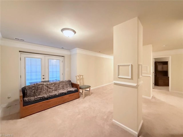 interior space with french doors, carpet flooring, and crown molding