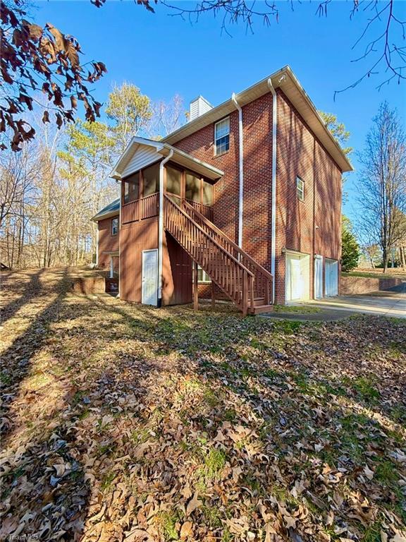 view of side of home featuring a sunroom