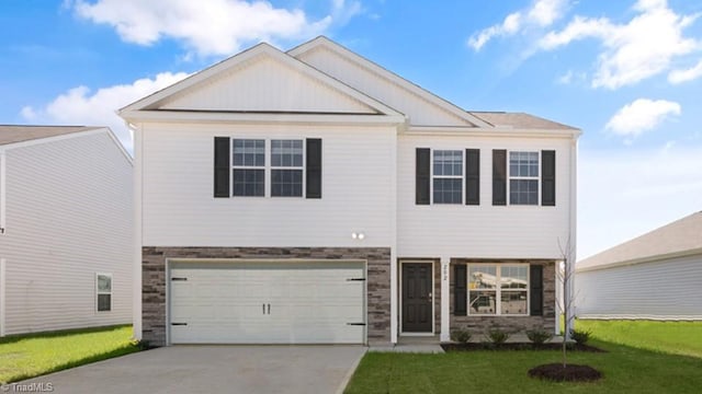 view of front of property featuring a garage, a front yard, stone siding, and concrete driveway