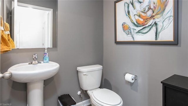 half bathroom featuring toilet