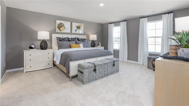 bedroom featuring baseboards and light carpet