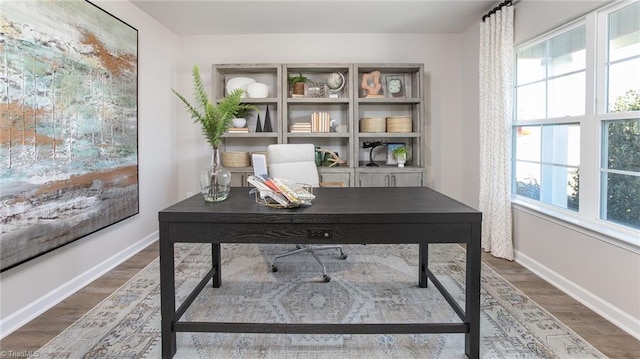 office area with baseboards and wood finished floors
