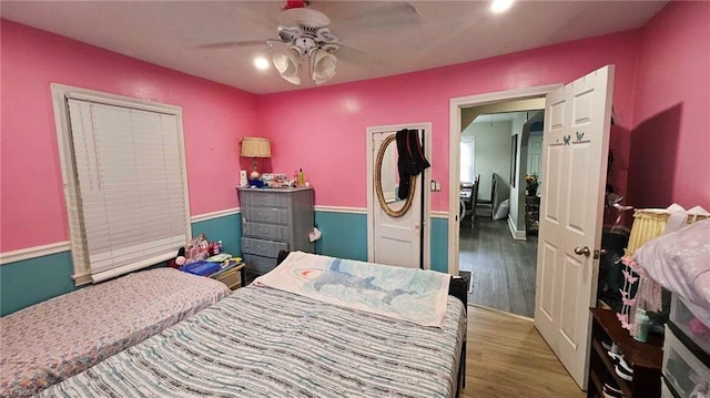 bedroom with hardwood / wood-style flooring and ceiling fan