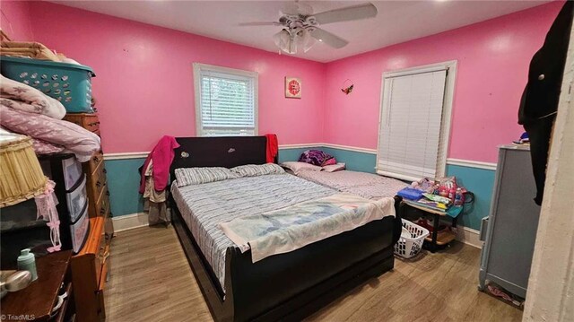 bedroom with hardwood / wood-style floors and ceiling fan