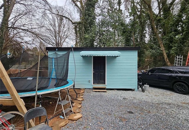 view of outbuilding with a trampoline