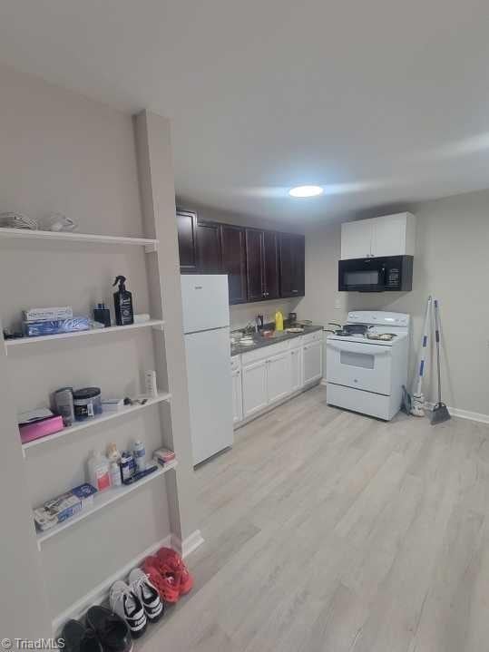 kitchen with white cabinetry, white appliances, dark brown cabinetry, and light hardwood / wood-style floors