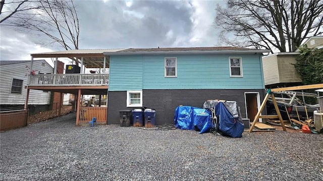 back of house with a wooden deck