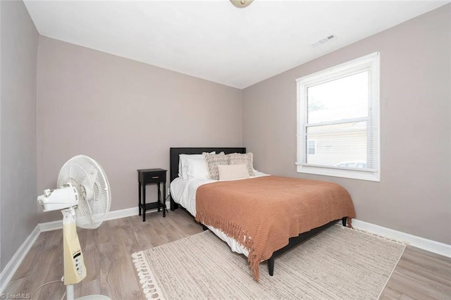 bedroom featuring light wood-style flooring and baseboards