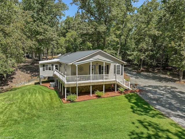 back of house with a yard, central AC unit, and a porch