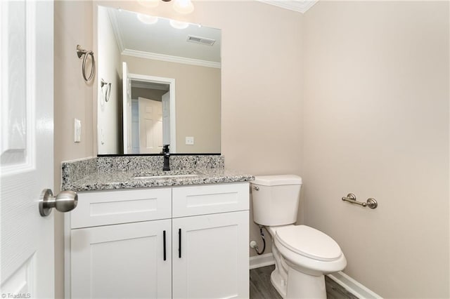 512 Guilford Ave, High Point, NC 27262 - bathroom with crown molding, toilet, vanity, wood finished floors, and baseboards