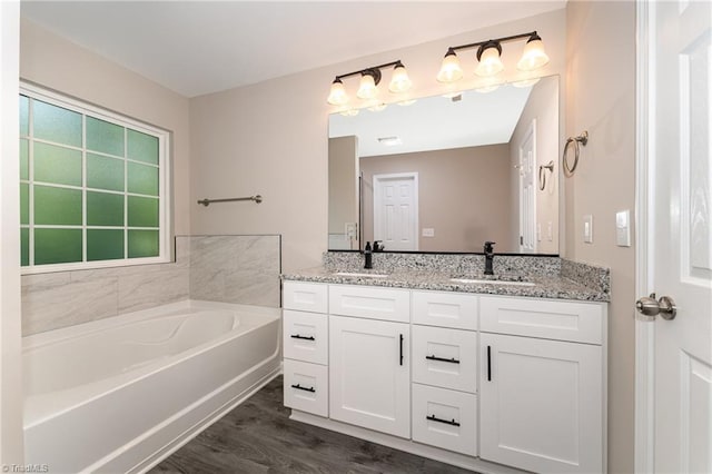 512 Guilford Ave, High Point, NC 27262 - full bath with double vanity, a bath, and wood finished floors
