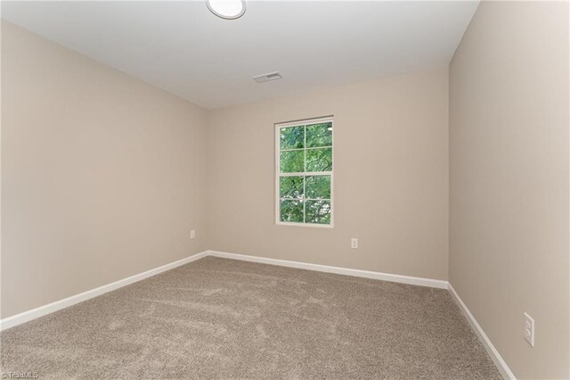 512 Guilford Ave, High Point, NC 27262 - carpeted spare room featuring baseboards