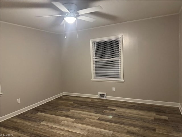 empty room featuring dark hardwood / wood-style flooring, ceiling fan, and crown molding