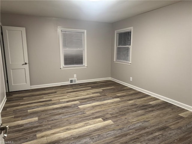 spare room with dark wood-type flooring