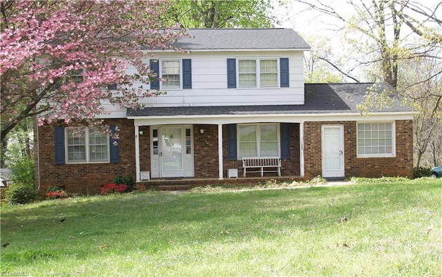 2142 Brighton Ct, Winston-Salem, NC 27103 - view of front of home with brick siding, a front yard, a porch, and a shingled roof