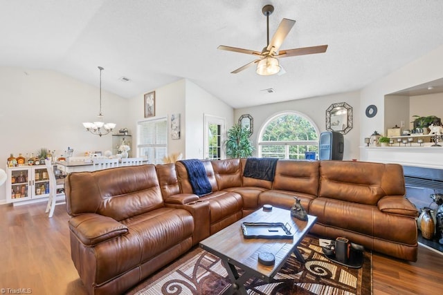 6112 Hedgecock Cir Unit 3B, High Point, NC 27265 - living room featuring lofted ceiling, a chandelier, wood finished floors, ceiling fan, and a textured ceiling