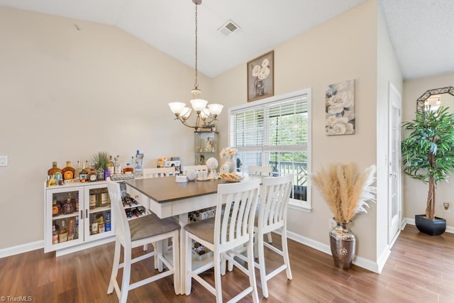 6112 Hedgecock Cir Unit 3B, High Point, NC 27265 - dining space with a chandelier, wood finished floors, lofted ceiling, and baseboards