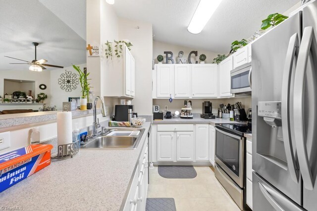 6112 Hedgecock Cir Unit 3B, High Point, NC 27265 - kitchen featuring appliances with stainless steel finishes, a sink, a ceiling fan, light countertops, and lofted ceiling