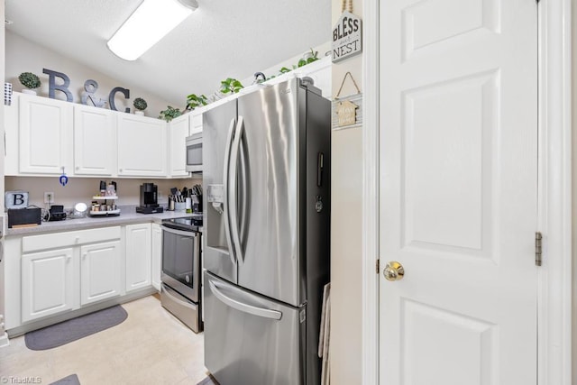 6112 Hedgecock Cir Unit 3B, High Point, NC 27265 - kitchen featuring stainless steel appliances, white cabinetry, light countertops, light flooring, and a textured ceiling