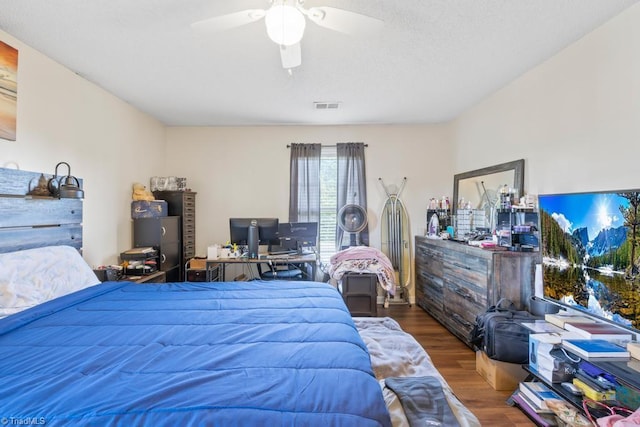6112 Hedgecock Cir Unit 3B, High Point, NC 27265 - bedroom with wood finished floors, a ceiling fan, and a desk