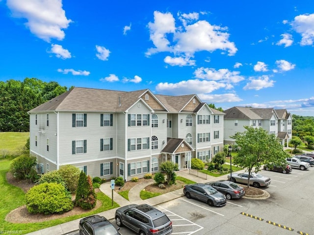 6112 Hedgecock Cir Unit 3B, High Point, NC 27265 - view of building exterior with uncovered parking and a residential view