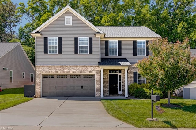 4548 River Gate Dr, Clemmons, NC 27012 - traditional-style house featuring concrete driveway, a garage, a front lawn, and brick siding