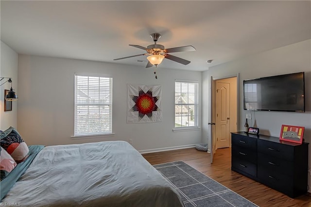 4548 River Gate Dr, Clemmons, NC 27012 - bedroom with multiple windows, dark wood-style flooring, baseboards, and a ceiling fan