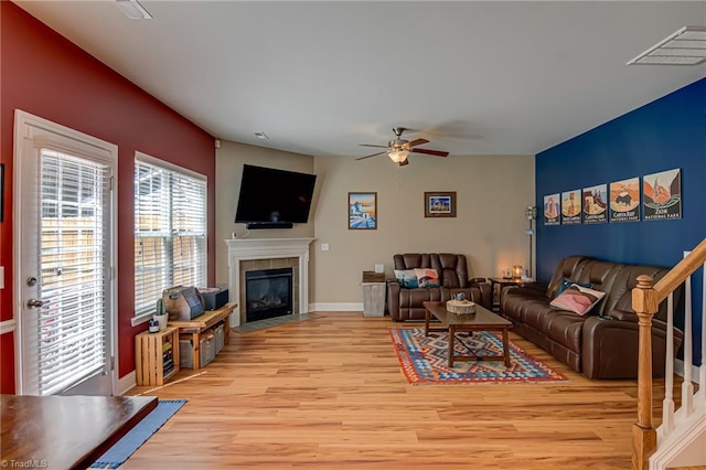 4548 River Gate Dr, Clemmons, NC 27012 - living room featuring ceiling fan, light wood-style floors, a tile fireplace, and baseboards