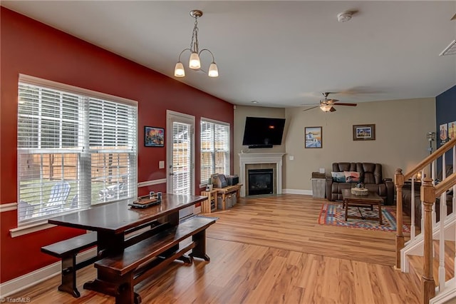 4548 River Gate Dr, Clemmons, NC 27012 - living room with light wood finished floors, a glass covered fireplace, ceiling fan, baseboards, and stairs