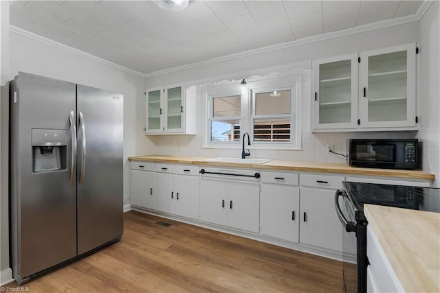 kitchen featuring sink, backsplash, ornamental molding, black appliances, and white cabinets