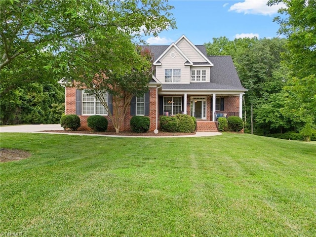 view of front facade with covered porch and a front lawn