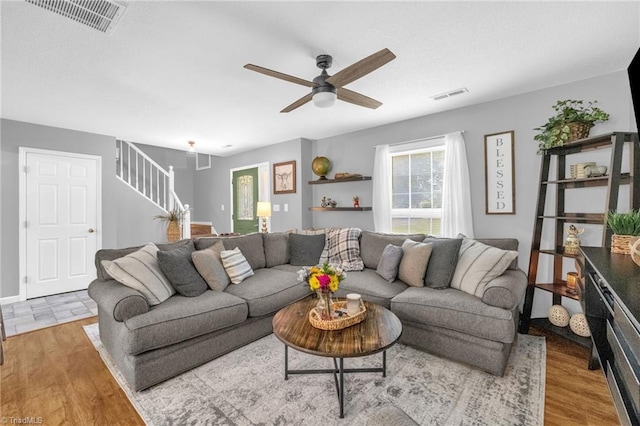 6937 US Highway 158, Stokesdale, NC 27357 - living room featuring ceiling fan, stairs, and wood finished floors