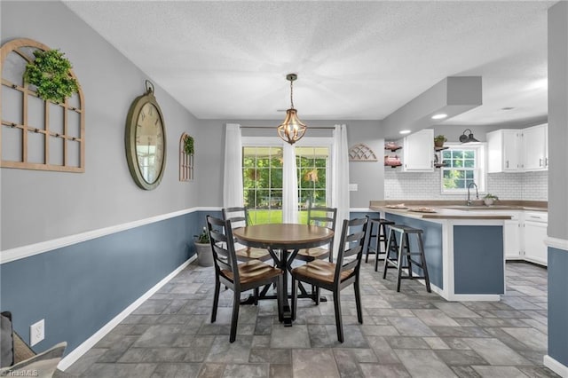 6937 US Highway 158, Stokesdale, NC 27357 - dining area featuring a textured ceiling and stone finish floors