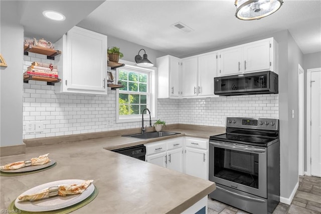 6937 US Highway 158, Stokesdale, NC 27357 - kitchen with stainless steel electric range oven, open shelves, white cabinets, dishwasher, and light countertops