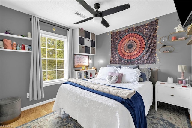 6937 US Highway 158, Stokesdale, NC 27357 - bedroom featuring wood finished floors and a ceiling fan