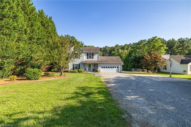 6937 US Highway 158, Stokesdale, NC 27357 - view of front facade with gravel driveway, an attached garage, a front yard, and a wooded view