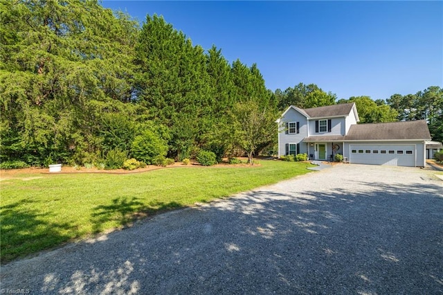 6937 US Highway 158, Stokesdale, NC 27357 - view of front of house featuring gravel driveway, an attached garage, a front lawn, and a forest view