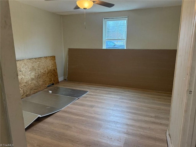 unfurnished room featuring light wood-type flooring and ceiling fan