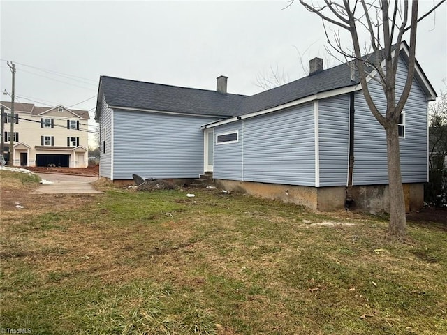 view of property exterior featuring a lawn