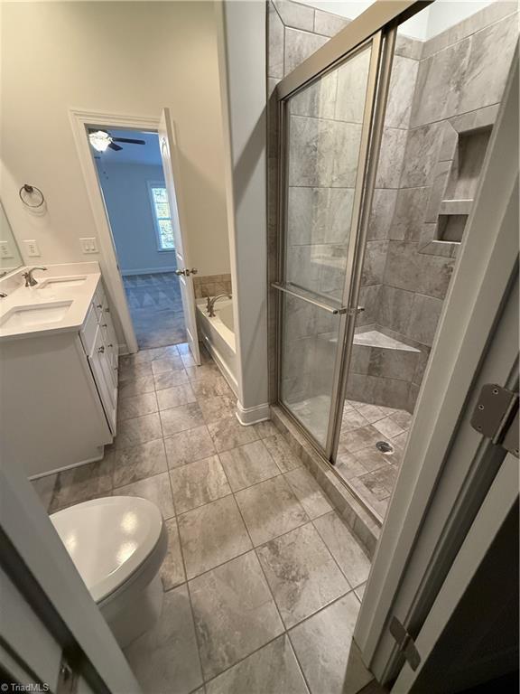 bathroom with vanity, tile patterned floors, independent shower and bath, and ceiling fan