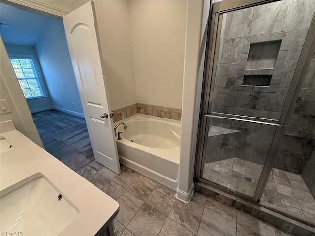 bathroom featuring plus walk in shower, vanity, and tile patterned floors