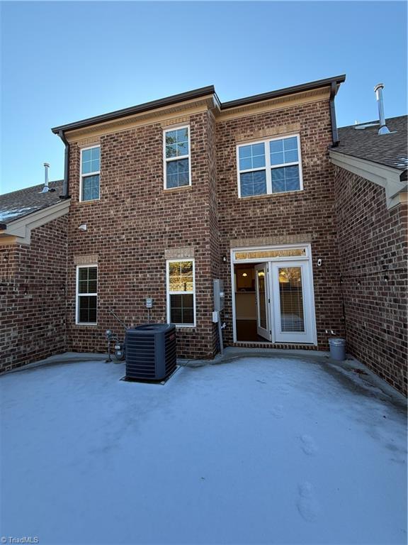 back of property featuring cooling unit and a patio